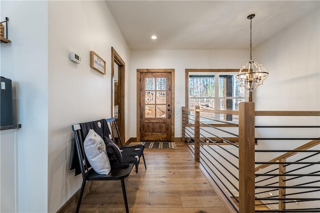 entrance foyer featuring recessed lighting, baseboards, a chandelier, and hardwood / wood-style flooring