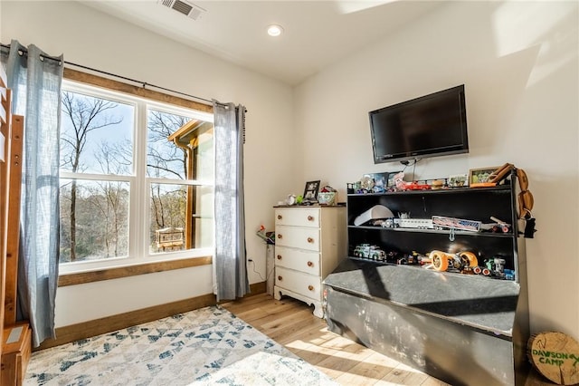 bedroom with recessed lighting, visible vents, baseboards, and wood finished floors