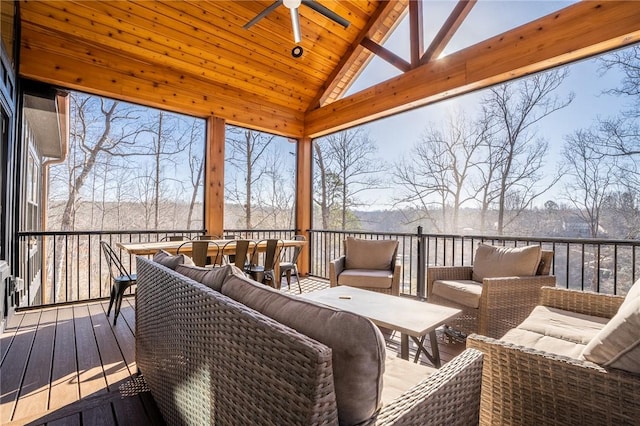 sunroom / solarium with wood ceiling, a ceiling fan, and vaulted ceiling