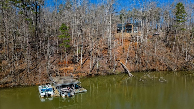 dock area featuring a forest view and a water view