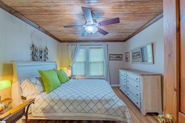 bedroom with ceiling fan, wooden ceiling, light wood-style floors, and ornamental molding