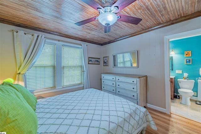 bedroom with baseboards, wood ceiling, ornamental molding, wood finished floors, and a ceiling fan