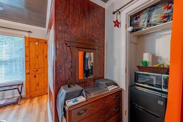 bedroom featuring crown molding and light wood-type flooring