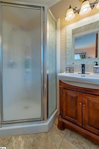 full bath featuring vanity and a shower stall