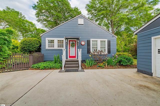 bungalow-style house with a garage and fence