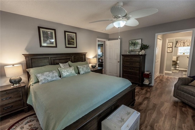 bedroom featuring baseboards, ceiling fan, and dark wood-style flooring