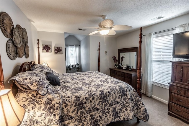 bedroom with visible vents, light colored carpet, a ceiling fan, and a textured ceiling