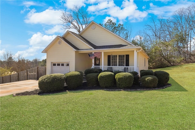 view of front facade with a porch, an attached garage, fence, and a front yard