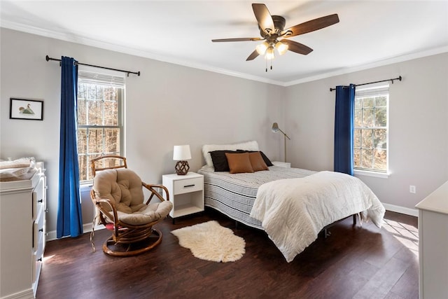 bedroom with baseboards, wood finished floors, and crown molding