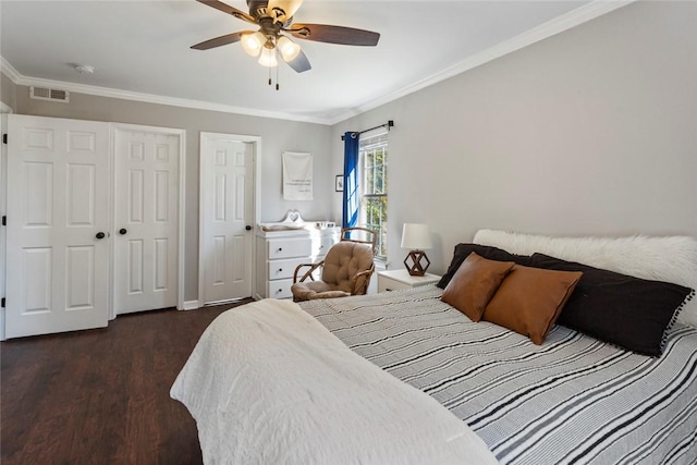 bedroom featuring ceiling fan, wood finished floors, visible vents, and ornamental molding