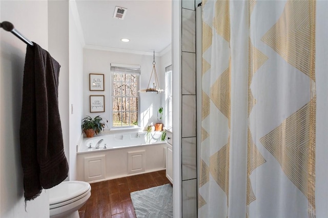 bathroom with visible vents, toilet, a shower with curtain, hardwood / wood-style floors, and crown molding