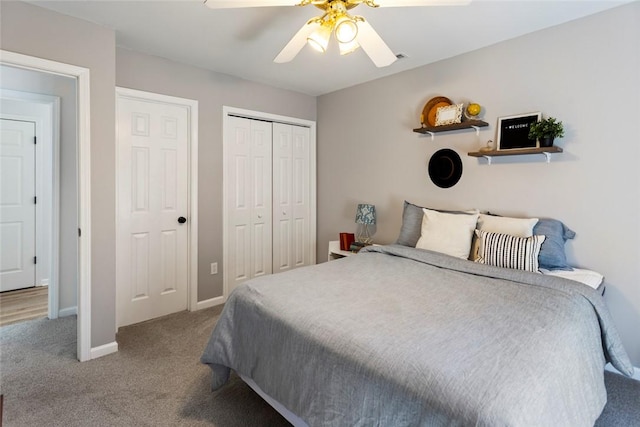 carpeted bedroom with a closet, baseboards, and a ceiling fan