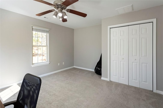 unfurnished office with visible vents, baseboards, a ceiling fan, and carpet flooring