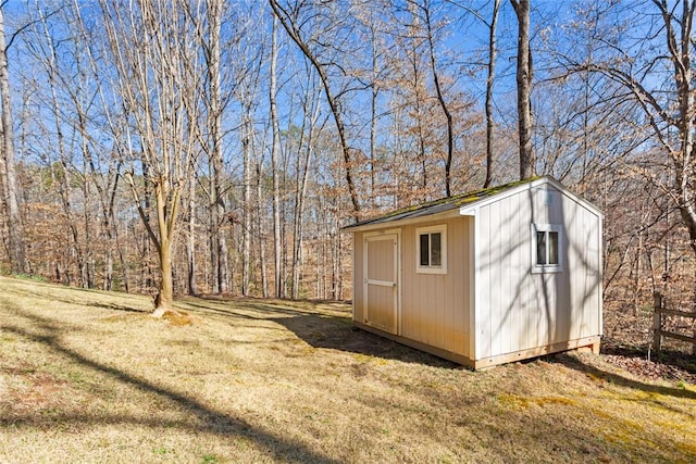 view of shed with a forest view