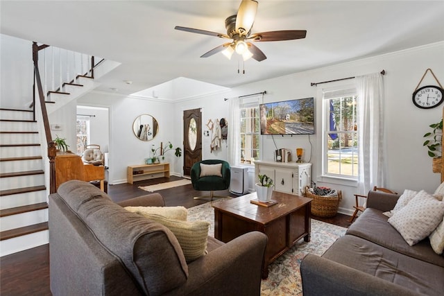 living area featuring a ceiling fan, wood finished floors, stairs, and ornamental molding