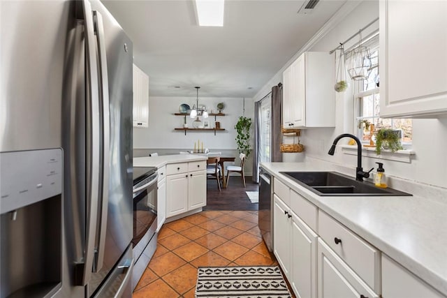 kitchen with visible vents, light countertops, appliances with stainless steel finishes, white cabinetry, and a sink