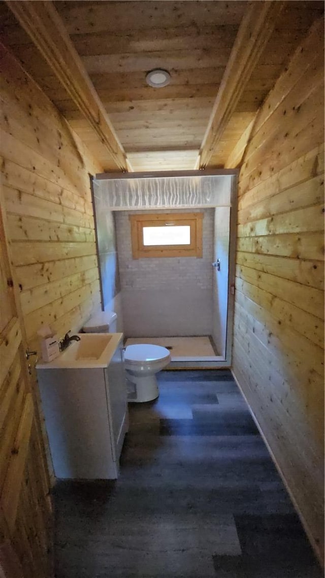 bathroom with wood finished floors, wooden walls, wooden ceiling, and toilet