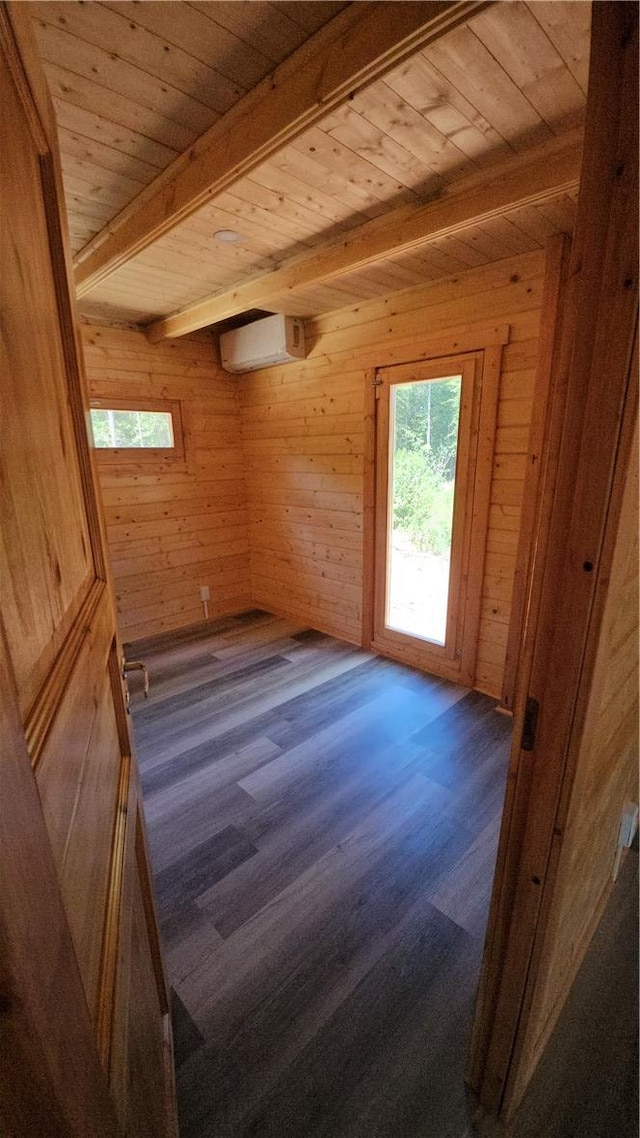 spare room with beamed ceiling, wooden ceiling, and a wall unit AC