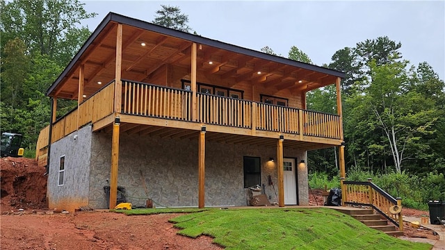 exterior space with stucco siding and a wooden deck