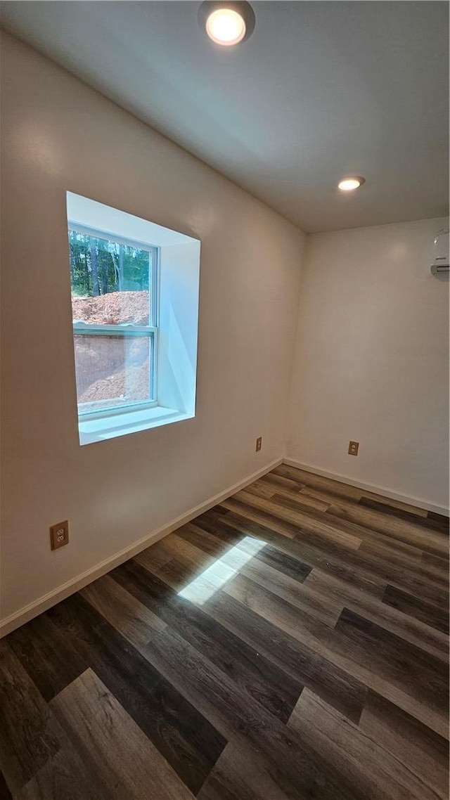 unfurnished room featuring dark wood-type flooring, recessed lighting, and baseboards