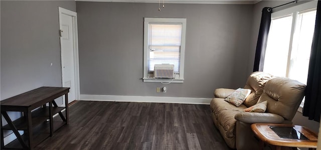 sitting room featuring cooling unit, baseboards, and dark wood-style floors