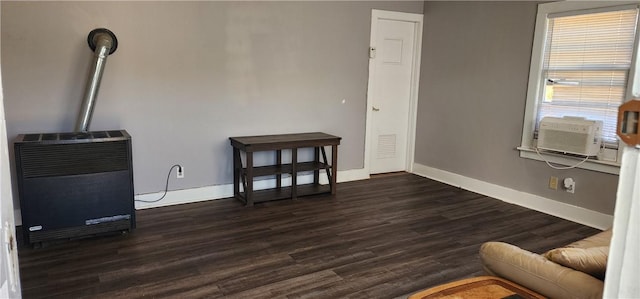 interior space featuring dark wood finished floors, heating unit, cooling unit, and baseboards