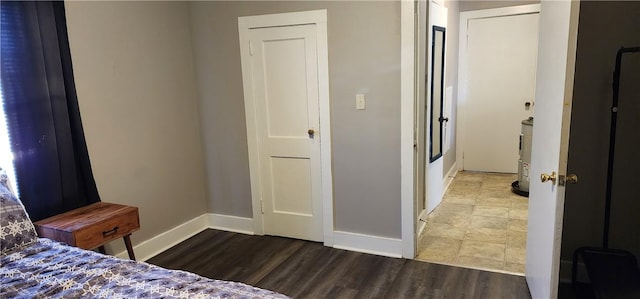 bedroom with wood finished floors and baseboards