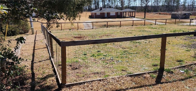 view of yard with a rural view and fence