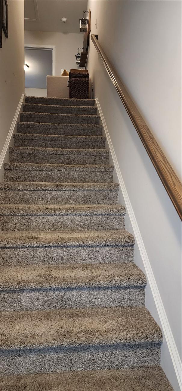 stairs featuring baseboards