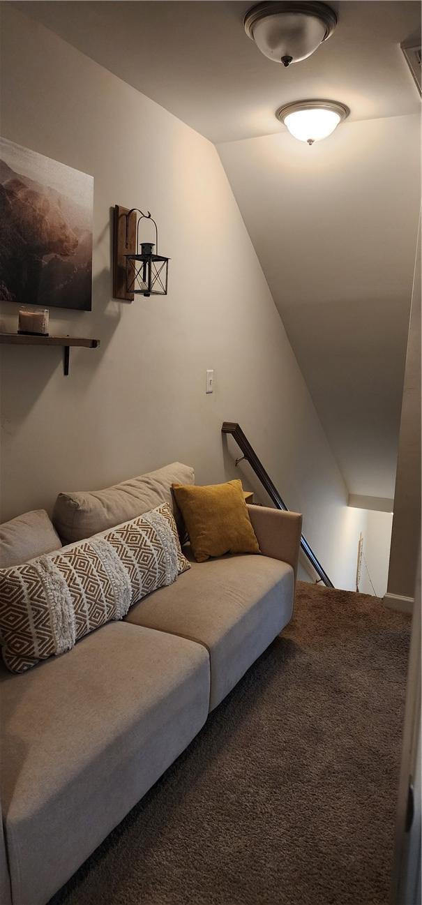 interior space with lofted ceiling and carpet flooring