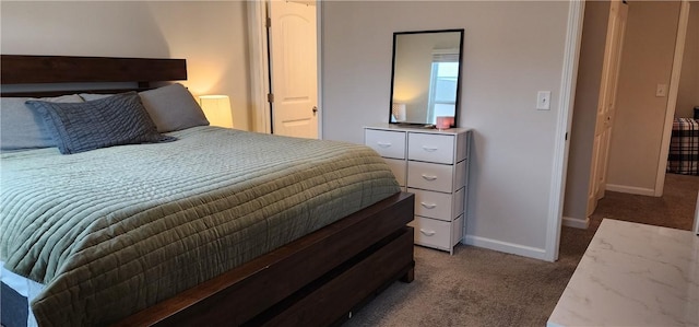 bedroom featuring baseboards and light carpet