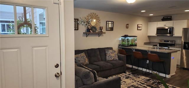 living room featuring dark wood-type flooring and recessed lighting