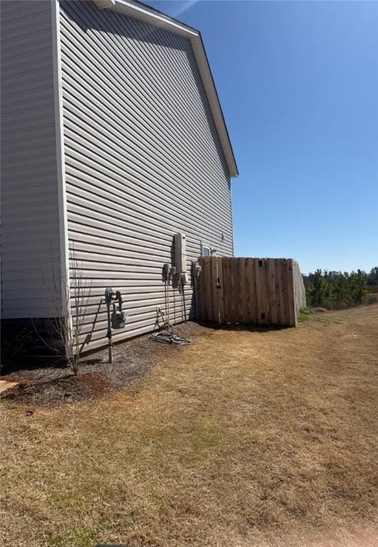 view of side of home featuring a yard