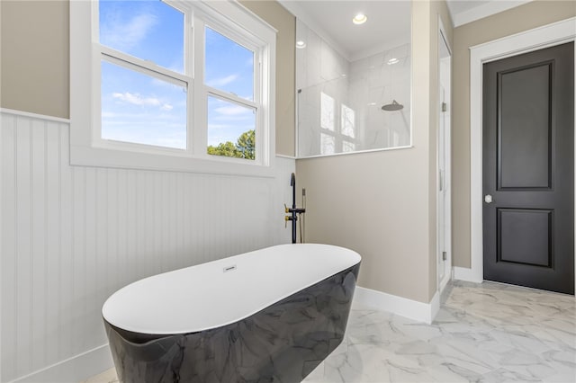 full bathroom featuring wainscoting, marble finish floor, walk in shower, and a freestanding tub