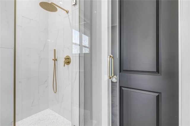 bathroom featuring a marble finish shower