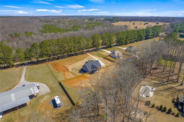 birds eye view of property featuring a view of trees