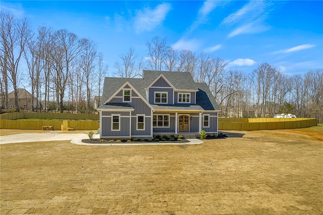 view of front of home featuring board and batten siding, a shingled roof, a front lawn, fence, and covered porch