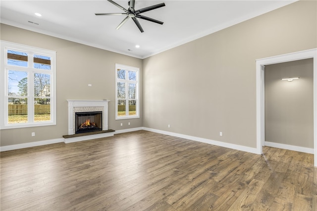 unfurnished living room with baseboards, wood finished floors, and a ceiling fan