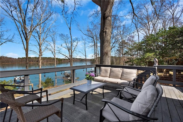 wooden terrace featuring an outdoor hangout area and a water view