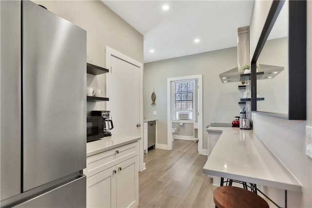 kitchen featuring open shelves, freestanding refrigerator, light wood-style floors, white cabinets, and black microwave