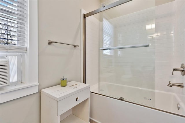 full bathroom with bath / shower combo with glass door