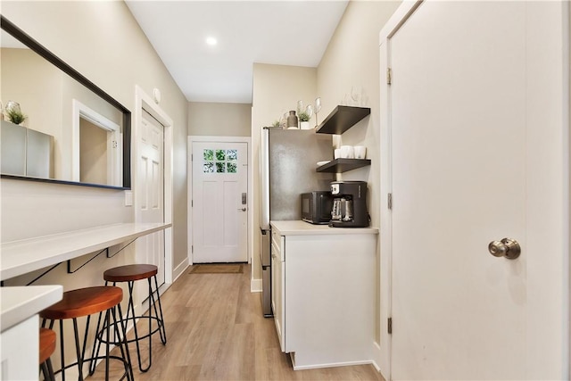 interior space with light wood-style floors and baseboards