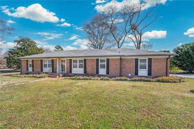 single story home with brick siding and a front yard