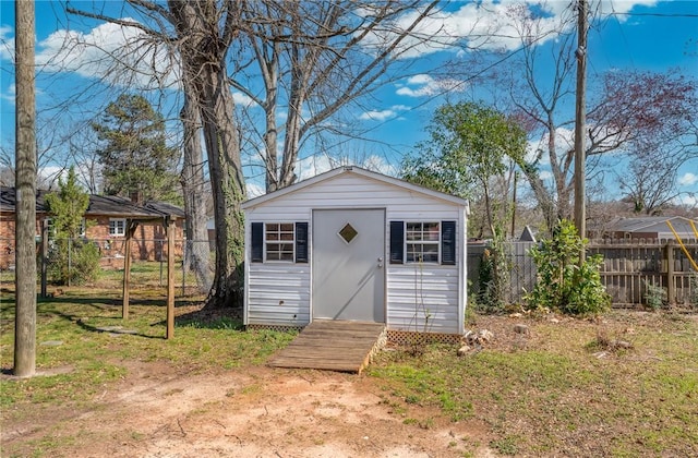 view of shed featuring fence