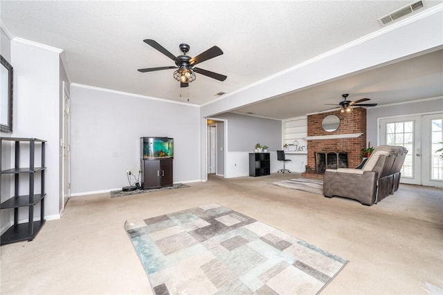 carpeted living room featuring visible vents, a fireplace, crown molding, baseboards, and ceiling fan