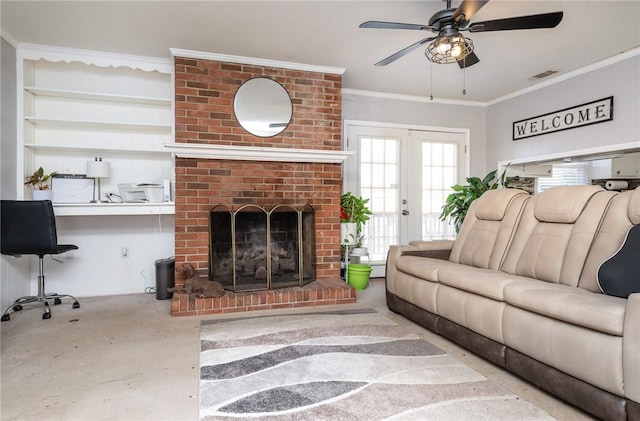 living area featuring visible vents, a ceiling fan, concrete floors, crown molding, and a brick fireplace