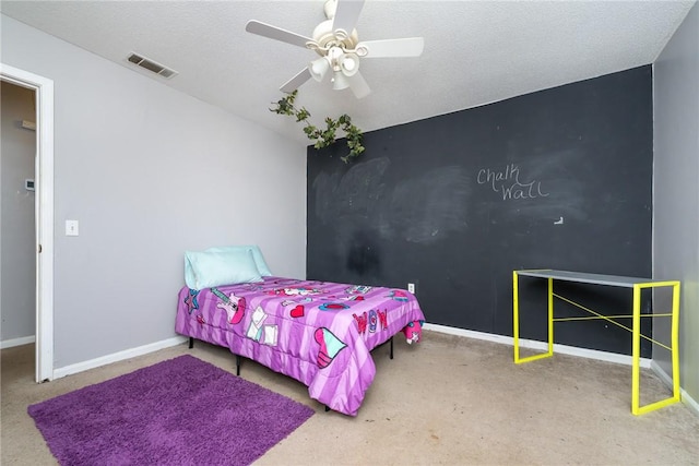 bedroom featuring visible vents, a ceiling fan, an accent wall, and baseboards