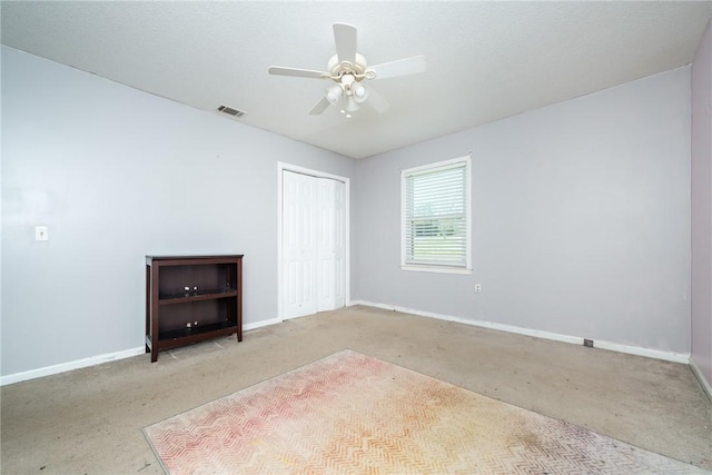 unfurnished bedroom featuring visible vents, baseboards, a closet, and ceiling fan