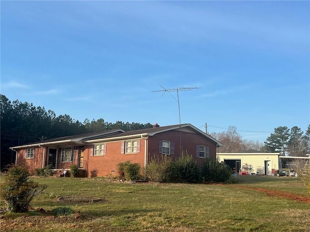 exterior space featuring a lawn, brick siding, and crawl space