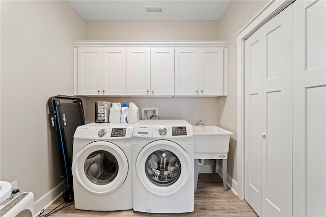 103 W Chestnut Cir, Central, SC 29630 - washroom featuring washer and dryer, cabinet space, and light wood-style floors